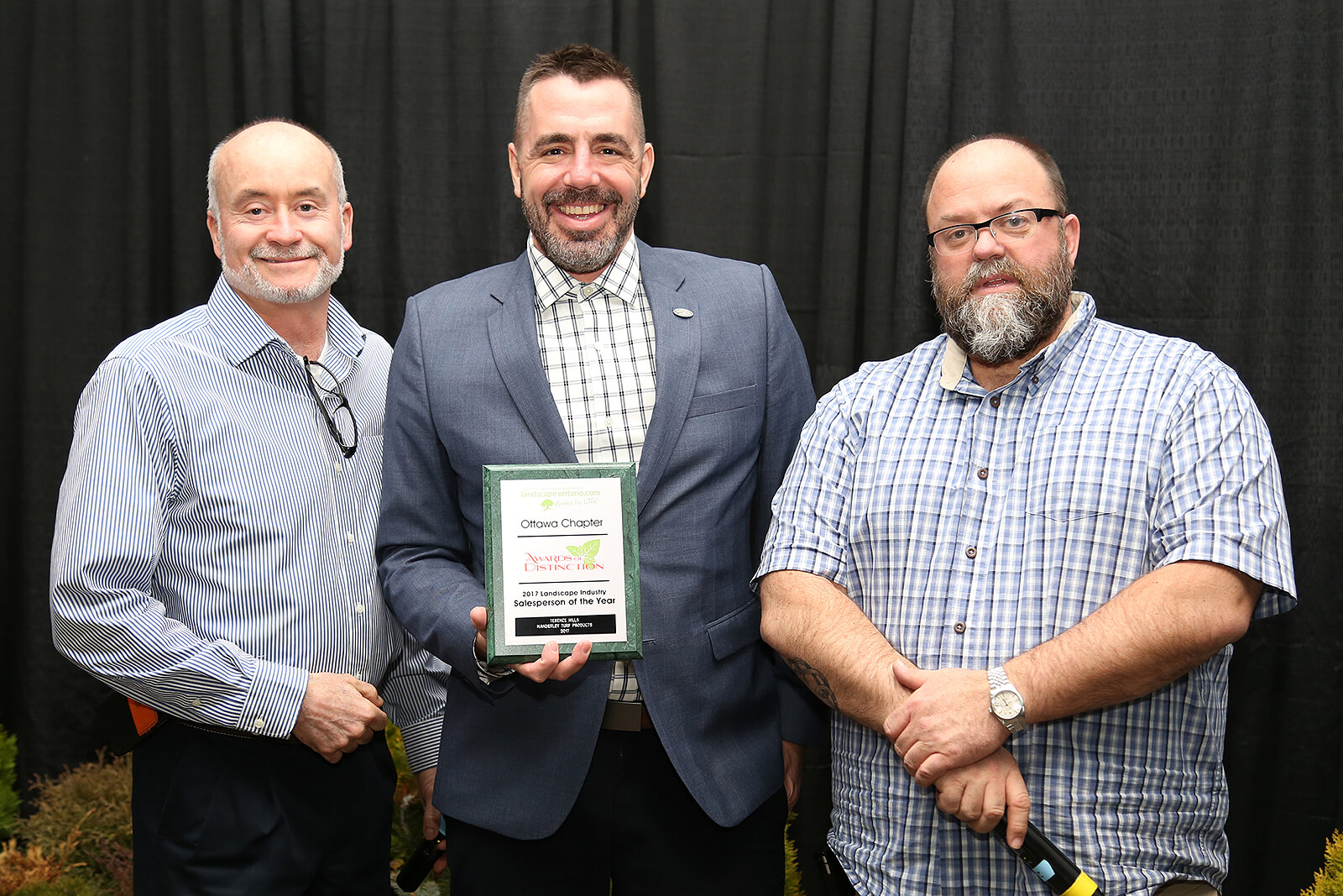Terrence Hills, 2017 Salesperson of the Year (centre), flanked by Ottawa Chapter’s Bruce Morton (left) and Ed Hansen (right).