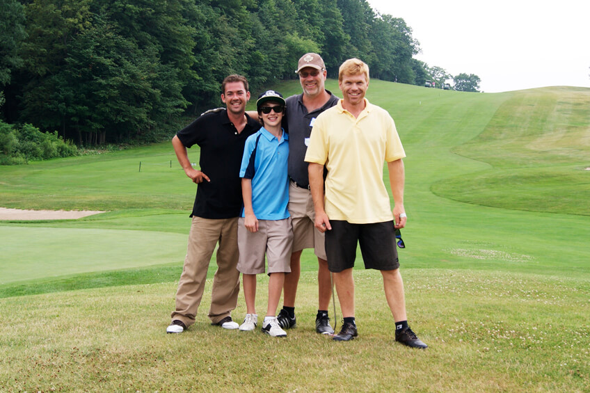 four men on a golf course