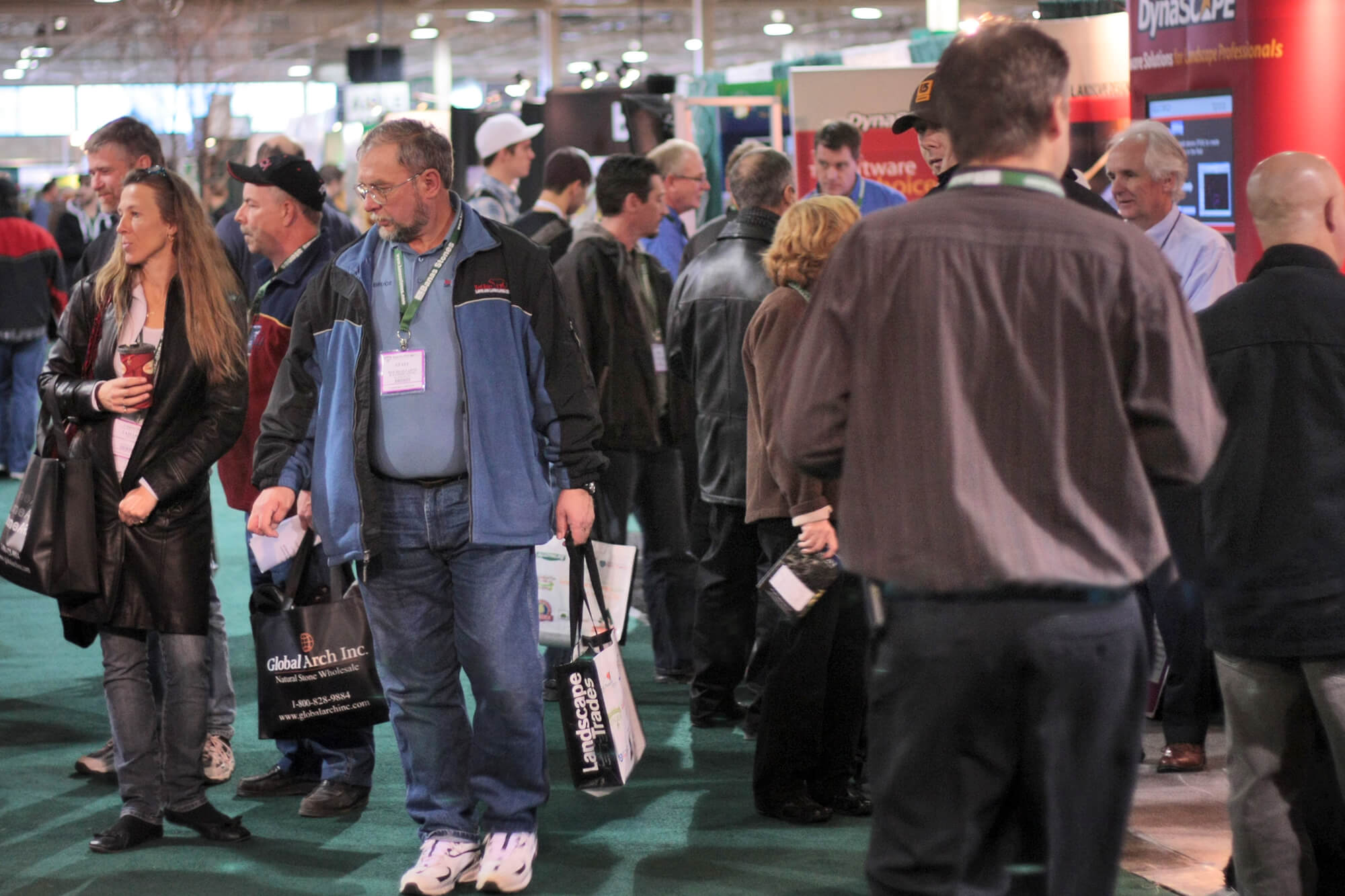 people walking the aisle at a trade show