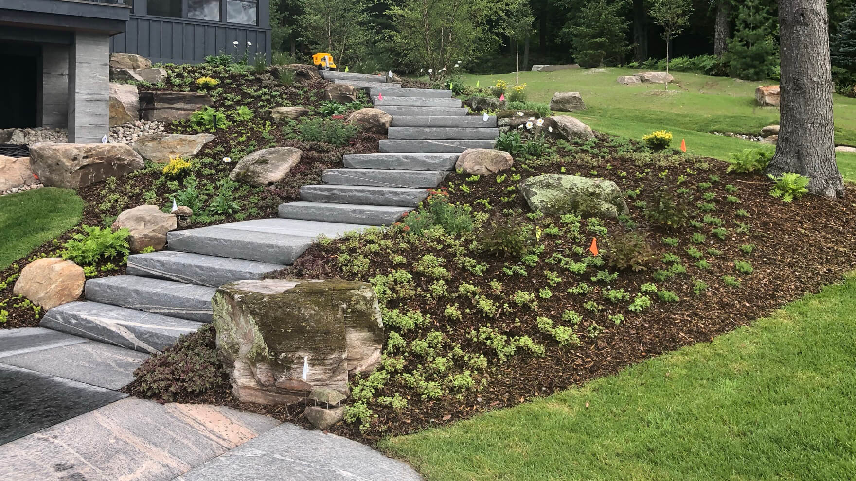 natural stone steps winding down a hil behind a house