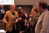 Keynote speaker, Mark Krautmann (left), talks with attendees during a break.