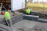 A crew from Bruce Wilson Landscaping rebuilds the loading dock at the LO office in Milton.