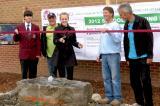 LO members, Jason Dietrich of Ace Lawncare, Thomas Blatter of Dreamestate Landscaping and Don Prosser of Don Prosser Landscape Design help students with the ribbon cutting at St. James Catholic High School garden.