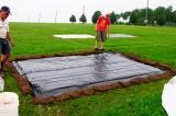 The polyethylene was put in place and the sod strips were placed over the edges of the poly and anchored in place using sod staples.