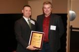 Michael LaPorte accepts the Service and Leadership Award from Volunteer of the Year recipient Nick Solty.