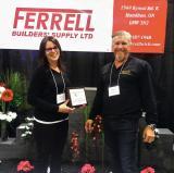 Alicia Reid and Chris DeCock from Ferrell Builders’ Supply accept the best booth award.