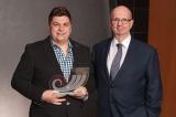 Scott Duff (left) receives his award from a representative from Grant Thornton LLP.