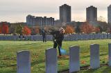 Mary Ann Westover prepares the grounds surrounded by grave stones in Beechwood Cemetery.