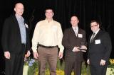 The Landmark Group of Thornbury received the Dynascape Award of Excellence for Landscape Design. In photo, from left, Mike Bosch, president of Dynascape; Gary Nordeman and Darren Bosch, both of The Landmark Group; and Joe Salemi, Dynascape product marketing manager.
