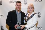 Matt Hill accepts the young entrepreneur of the year award from Brampton mayor Susan Fennell.