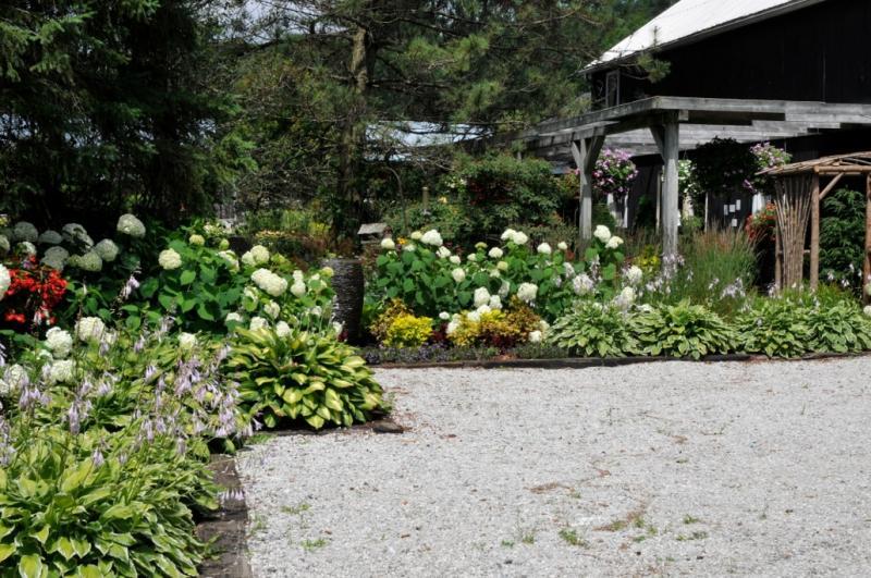 2014 - Permanent Display Gardens - Over 500 square feet - This is the front, customers see this as they drive in and park here in the driveway. This side gets the most amount of light, and annals are planted here each summer amongst the perennials for a splash of colour.
