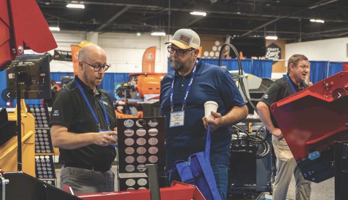 two men talking at a trade show
