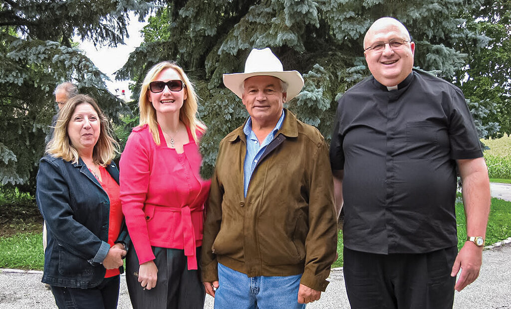 Two women and two men standing for a photograph.