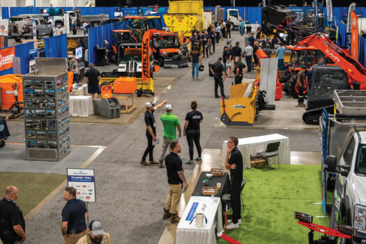an overhead shot of an indoor trade show with snow removal equipment