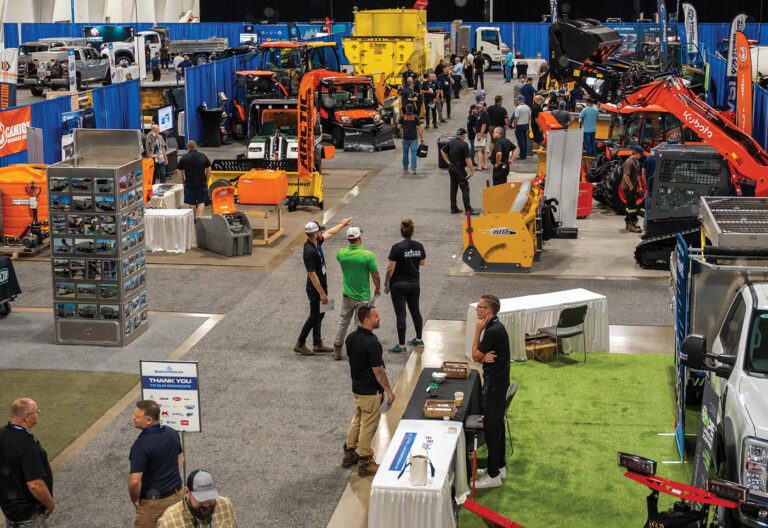 an overhead shot of an indoor trade show with snow removal equipment